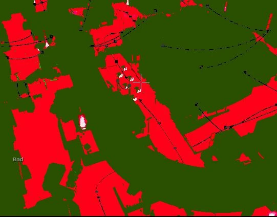 The shader complexity view over part of the track, most of the scene dark green with large areas of red along the ground